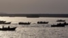(FILES) Iranian boats loaded with smuggled goods cruise through the Strait of Hormuz near Oman's Khasab port on July 14, 2012.