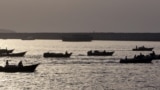 (FILES) Iranian boats loaded with smuggled goods cruise through the Strait of Hormuz near Oman's Khasab port on July 14, 2012.