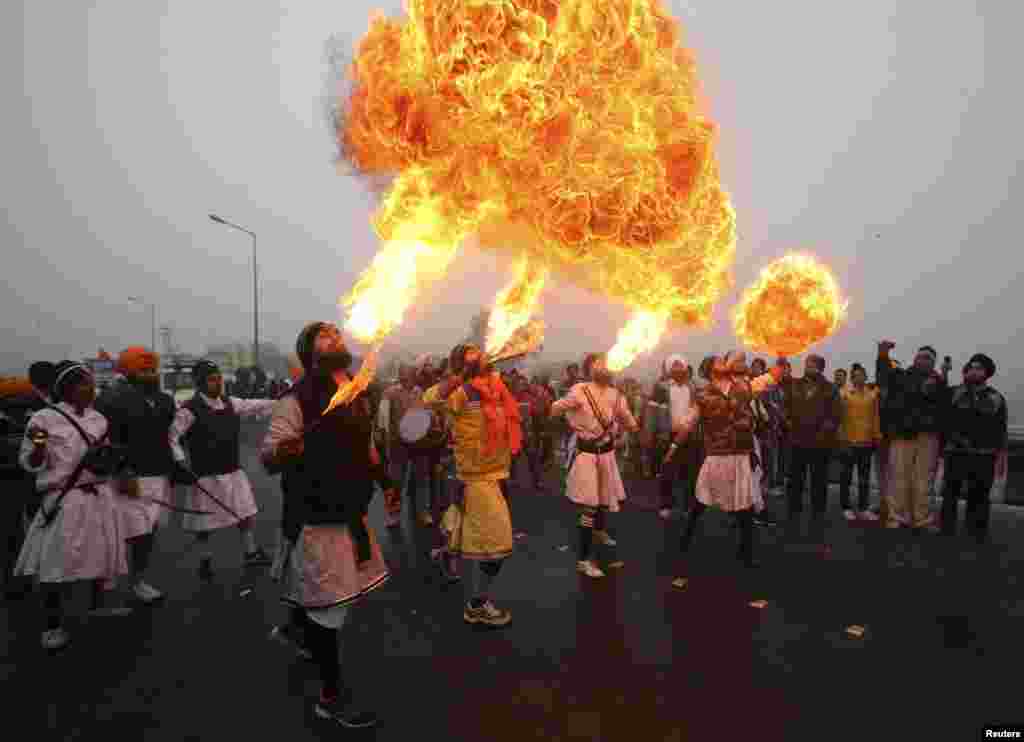 Sikh devotees show off their fire blowing skills during a religious procession ahead of the birth anniversary of Guru Gobind Singh in Jammu, on January 5. (Reuters/Mukesh Gupta)