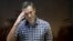 Russian opposition leader Aleksei Navalny stands in a glass cage at a Moscow court hearing on February 20. 