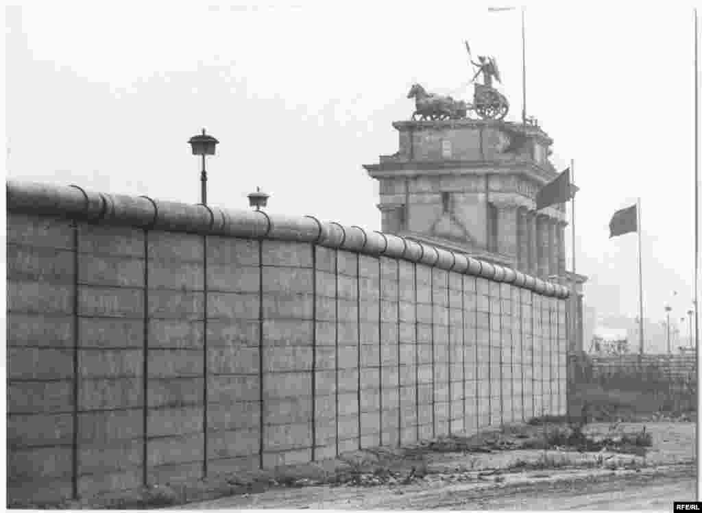 The wall with the Brandenburg Gate in the background. On June 12, 1987, near this site, U.S. President Ronald Reagan famously demanded of Soviet leader Mikhail Gorbachev: &quot;Mr. Gorbachev, tear down this wall.&quot;