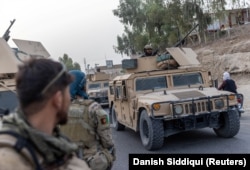 A convoy of Afghan special forces is seen during the rescue mission of a police officer besieged at a check post surrounded by Taliban fighters in Kandahar Province on July 13.