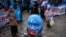 Uyghur protesters who have not heard from their families living in Xinjiang hold placards and Uyghur flags during a protest against China in Istanbul last month.