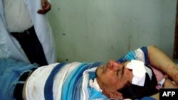 Al-Iraqiyah TV reporter Ibrahim al-Kateb, wounded in the blast, rests on a bed inside Baghdad's Yarmouk hospital.