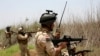 Iraqi security forces patrol outside the city of Fallujah.