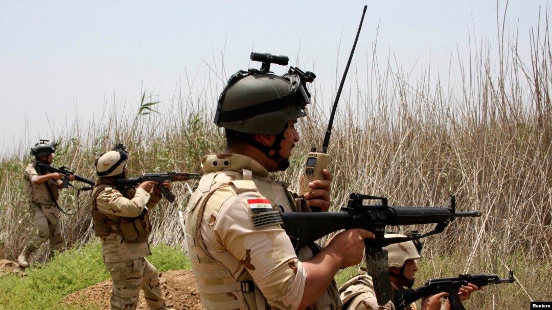 Iraqi security forces patrol outside the city of Fallujah.