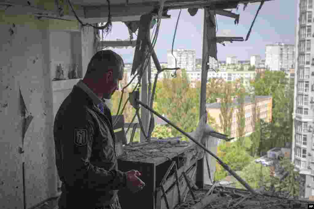 Kyiv Mayor Vitali Klitschko visits an apartment building damaged by a drone that was shot down during a Russian overnight strike in Kyiv.