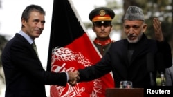 Afghan President Hamid Karzai (right) welcomed NATO Secretary-General Anders Fogh Rasmussen to Kabul on October 18.