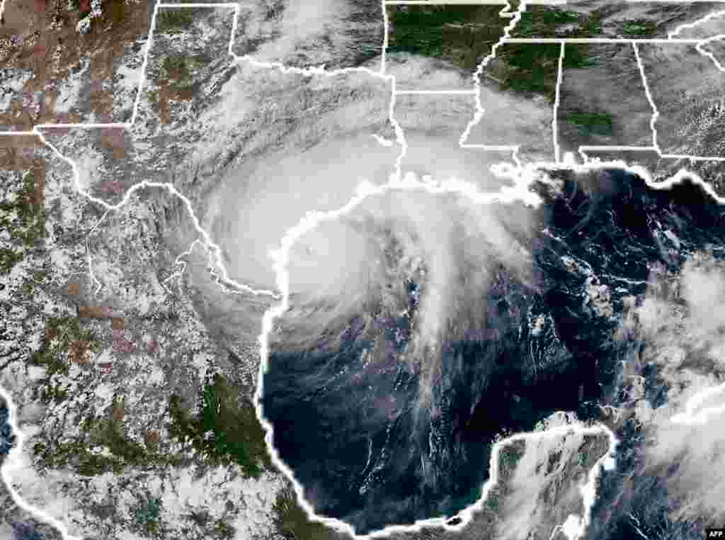 This National Oceanic and Atmospheric Administration satellite image taken on August 25, 2017, shows Hurricane Harvey (L) approaching the coast of Texas.