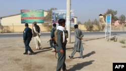 Afghan policeman take position during fighting between Taliban militants and Afghan security forces in Kunduz on October 3.