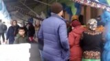 People wait in line to buy food at a market in Ashgabat in December 2019.