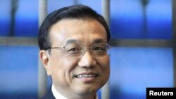 Chinese Vice Premier Li Keqiang stops to pose for a photo -- no questions, please! -- in Brussels on May 3.