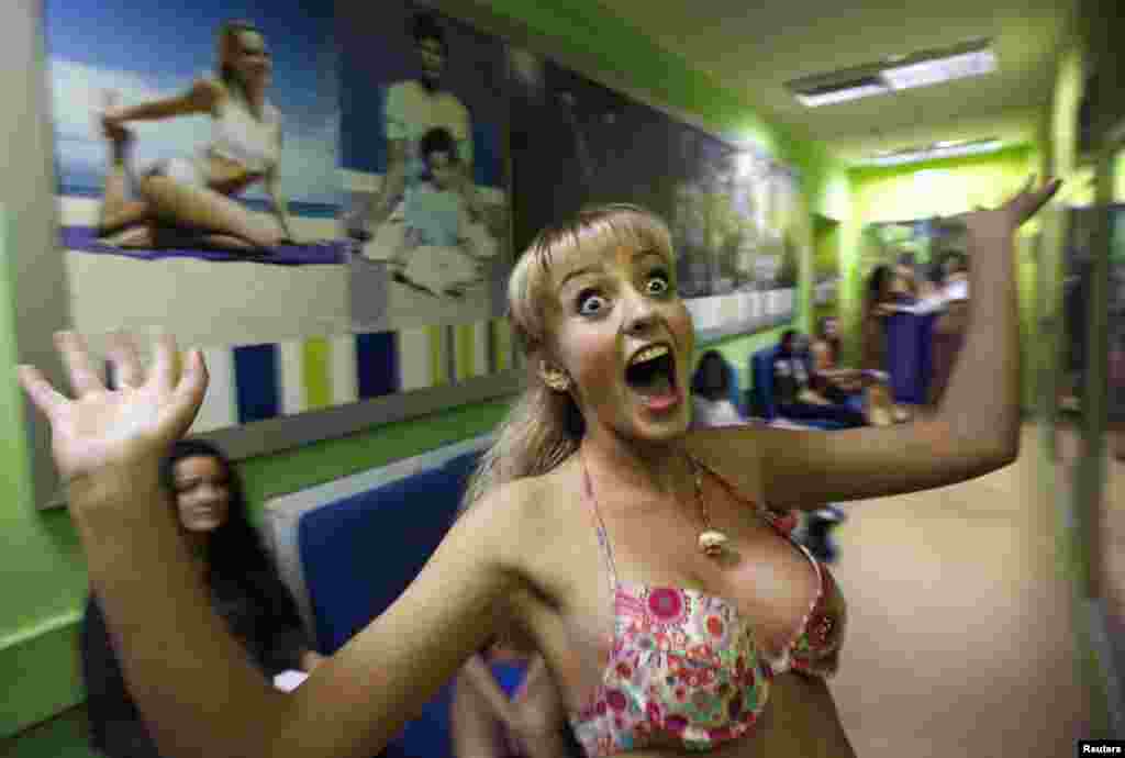 A contestant reacts backstage after participating in the first round of the "Krasa Rossii 2014" (Beauty of Russia 2014) beauty contest in the Siberian city of Krasnoyarsk. (Reuters/Ilya Naymushin)