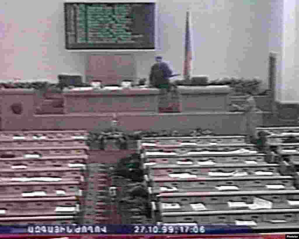 A screen grab from Armenian television shows the gunmen in the parliament chamber. - On October 27, 1999, five gunmen entered Armenia's parliament and opened fire, killing eight prominent politicians.