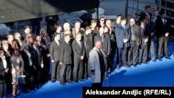 Vojislav Seselj addresses the crowd flanked by allies from his Serbian Radical Party at the rally in Belgrade on November 15.