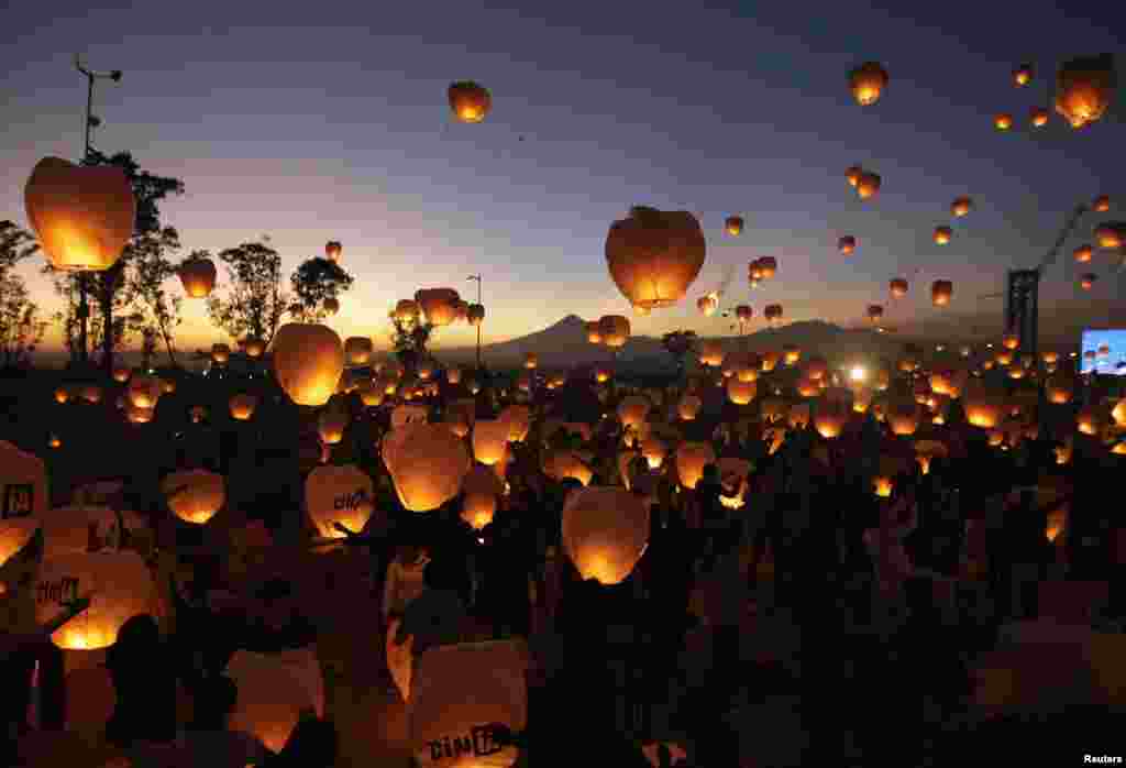 Participants launch Chinese lanterns during an event in Puebla, near Mexico City. Organizers hoped to break a Guinness world record by launching 16,000 lanterns, all of which were made by people with disabilities, according to local authorities. (Reuters/Imelda Medina)