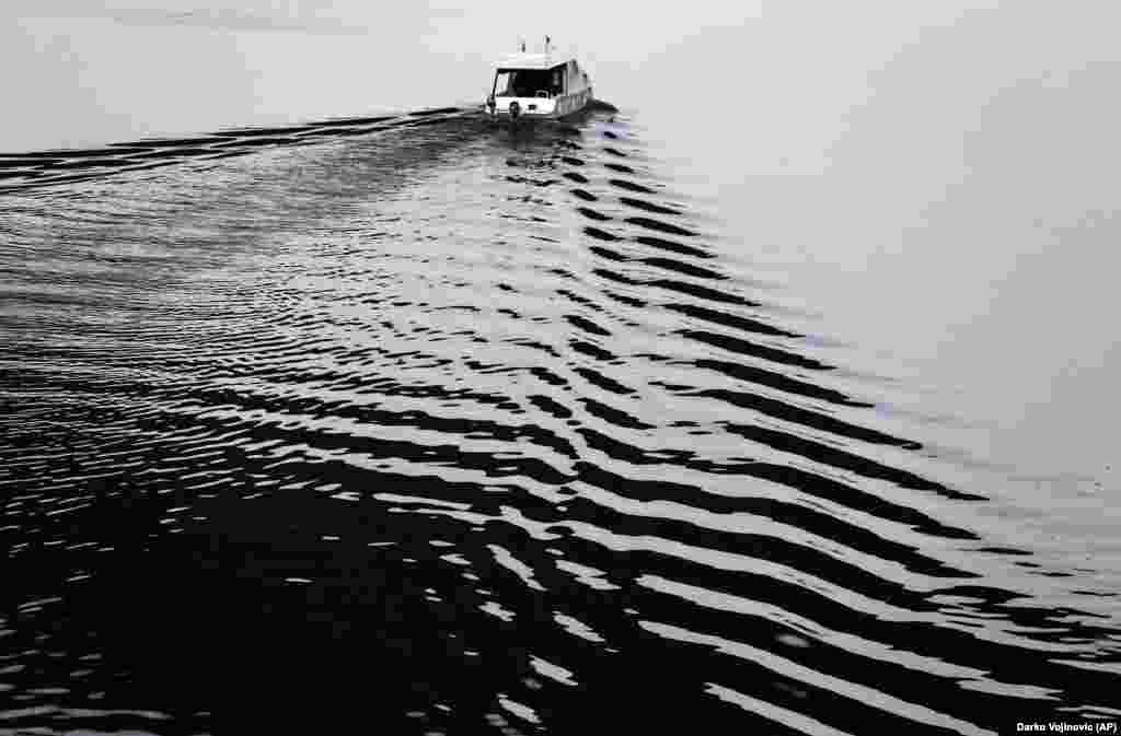 A boat floats on the Sava River in Belgrade on November 9. (AP/Darko Vojinovic)