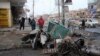 Iraqis inspect the site of a bomb attack in Baghdad, on January 14.