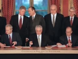 Slobodan Milosevic (left), Franjo Tudjman (center), and Alija Izetbegovic sign the peace agreement in Paris on December 14, 1995.