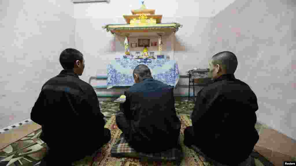 Tuvan inmates pray in a Buddhist prayer room at a male prison camp outside the Siberian city of Krasnoyarsk on March 22. (Reuters/Ilya Naymushin)