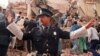 A police officer prevents people from approaching the site where a powerful explosion destroyed a seven-story building housing the Jewish Mutual Association of Argentina, in Buenos Aires, on July 18, 1994.