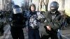 Ukrainian law enforcement officers detain a man following clashes with protesters on December 17 in Kyiv near parliament. 