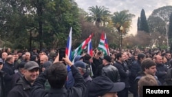 Protesters rally outside the parliament building in Sukhumi.