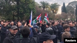 Protesters rally outside the parliament building in Sukhumi.