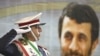 Iran -- A soldier salutes next to a portrait of President Mahmud Ahmadinejad during a celebration marking the 29th anniversary of the Islamic revolution at the mausoleum of Khomeini, in Tehran, 01Feb2008