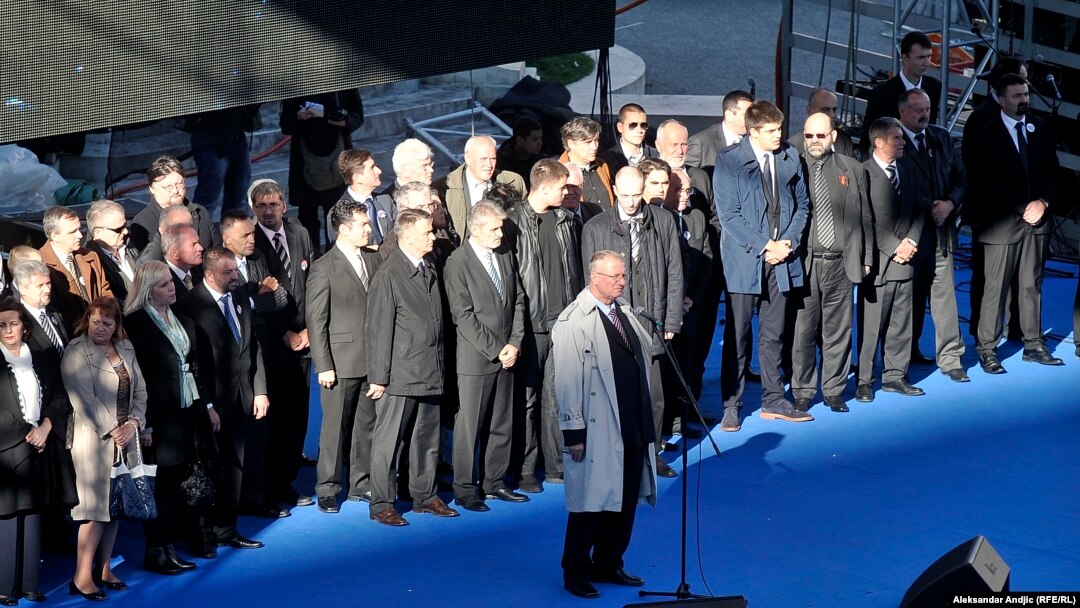 Vojislav Seselj addresses the crowd flanked by allies from his Serbian Radical Party at the rally in Belgrade on November 15.