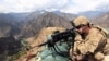 FILE: A U.S. soldier looks trough his sniper scope at a observation post in the eastern Afghan province of Kunar near the border with Pakistan.