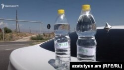 Armenia -- Homemade vodka sold on a roadside.