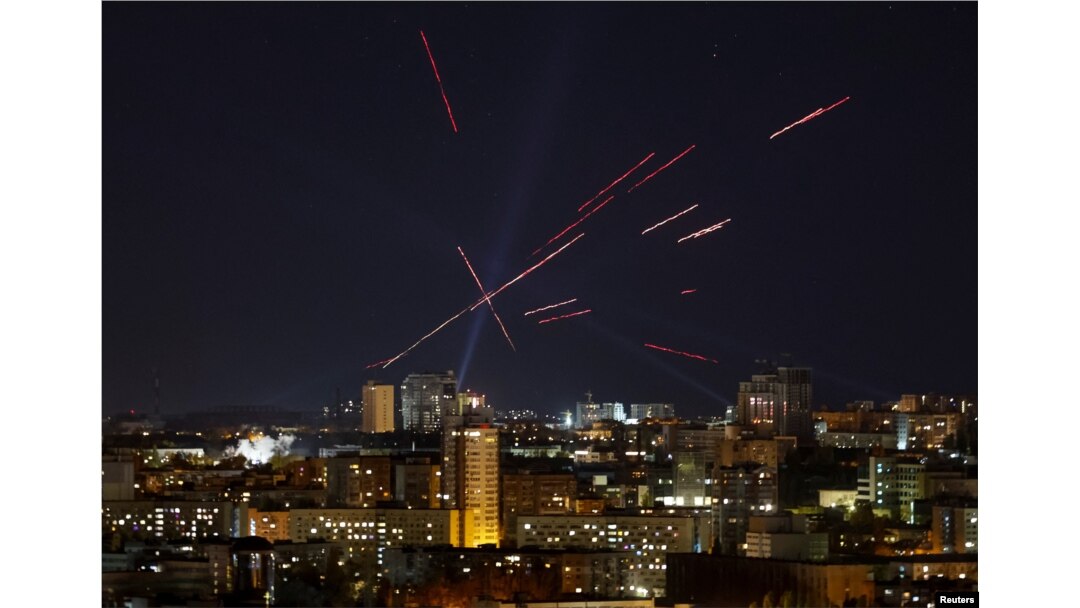 Tracers and searchlights are seen over Kyiv as Ukrainians fire at a drone during a Russian strike.