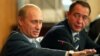 Russian President Vladimir Putin (left) gestures as Media Minister Mikhail Lesin listens to him during a meeting with local press in the far eastern city of Vladivostok in August 2002.