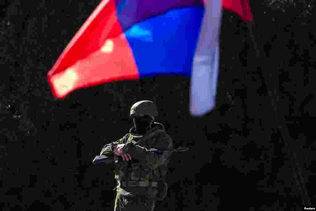 An armed man stands outside the Cabinet of Ministers building in Simferopol, the regional capital of Crimea.