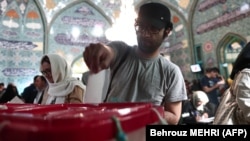 An Iranian man casts his ballot for the presidential election at a polling station in Tehran on May 19.