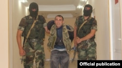 Azerbaijan - Azerbaijan soldiers escort Karen Petrosian, an Armenian man arrested after crossing into Azerbaijan, 7Aug2014 