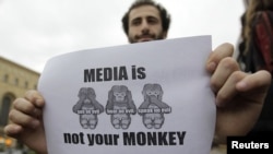 A man holds a banner during a rally to mark World Press Freedom Day in Tbilisi on May 3.