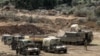 Israeli army vehicles deploy at a position along the border with Lebanon in northern Israel on October 1, 2024.