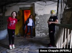 Children play inside a rundown Soviet-era apartment block in the suburbs of Yerevan.