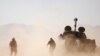 Hezbollah fighter walk near a military tank in Western Qalamoun, Syria August 23, 2017