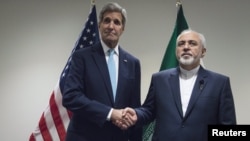 U.S. Secretary of State John Kerry (left) assured Iranian Foreign Minister Mohammad Javad Zarif that the administration can work around the new law.