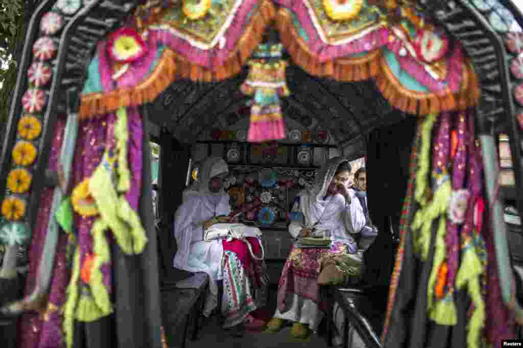 Students sit in public transport outside the Psychology Department of the University of Peshawar, Pakistan. (Reuters/Zohra Bensemra)