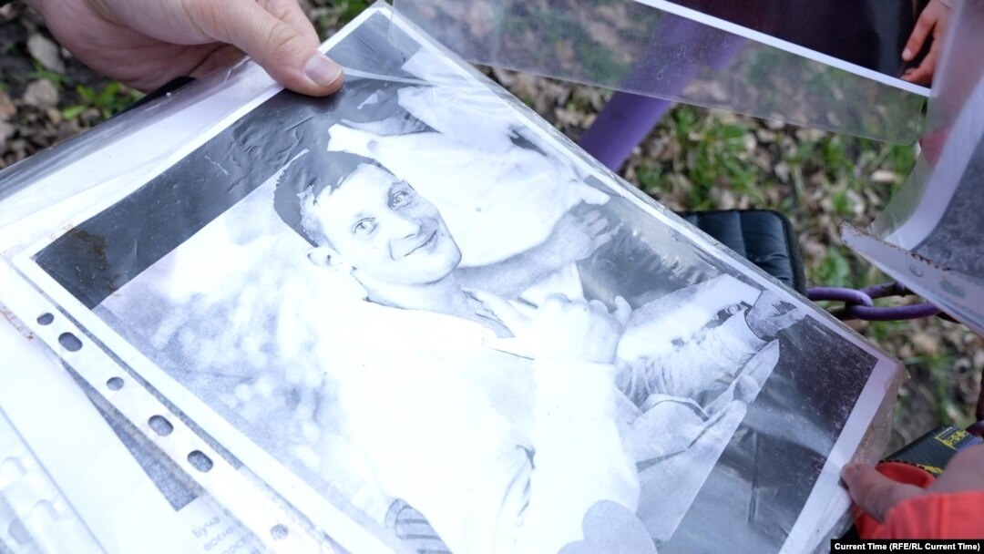 Vladyslav Popovych's mother shows Current Time a photo of her son. He is still in prison in Russia, three years after being taken by Russian troops in the Ukrainian city of Bucha. 