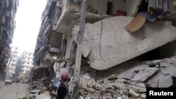 Члени опозиційної Вільної сирійської армії дивляться на зруйновану будівлю в Алеппо, 19 лютого 2013 року