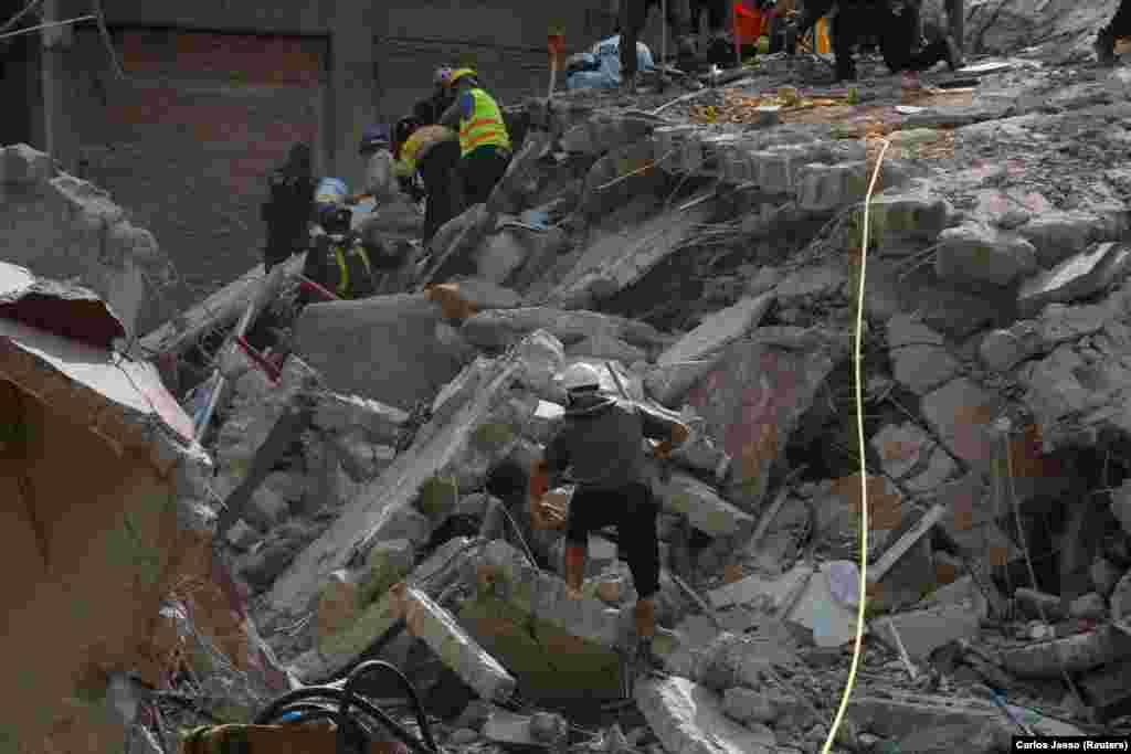 MEXICO -- People clear rubble after an earthquake hit Mexico City, Mexico September 19, 2017