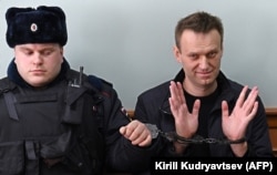 Kremlin critic Aleksei Navalny gestures during a court hearing in Moscow in 2017.