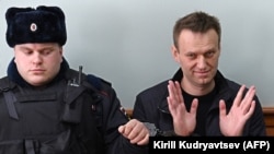 Kremlin critic Aleksei Navalny (right) gestures during his appeal hearing at a court in Moscow on March 30. 