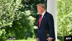 US President Donald Trump arrives during a Mother's Day luncheon in the Rose Garden of the White House in Washington, DC, on May 8, 2026.