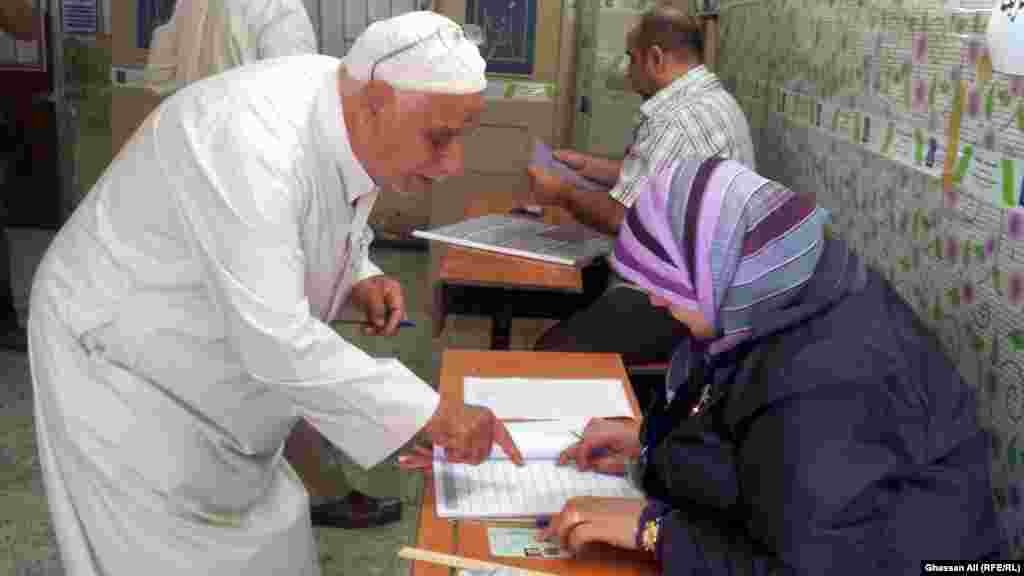An elderly man looks for his name in the voters&#39; register in Baghdad.